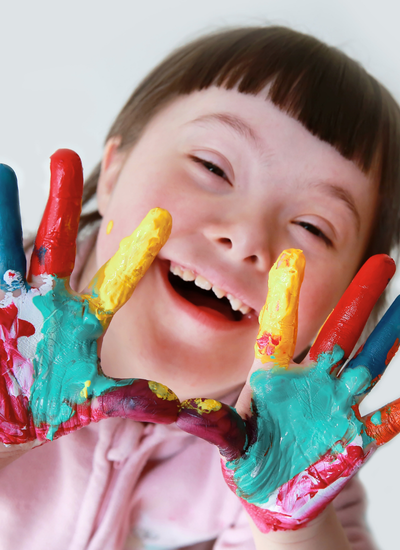 Joyful girl with Down syndrome engaged in learning – inclusive tutoring for students with developmental delays and intellectual disabilities